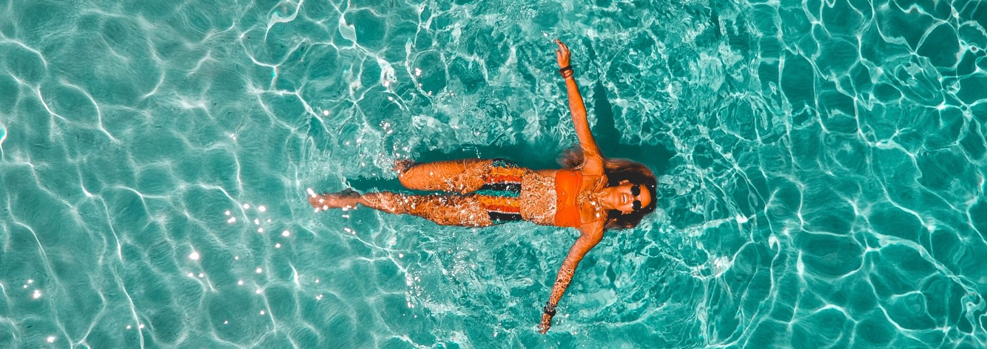 woman swimming alone in body of water